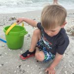 An image of a boy on the beach.